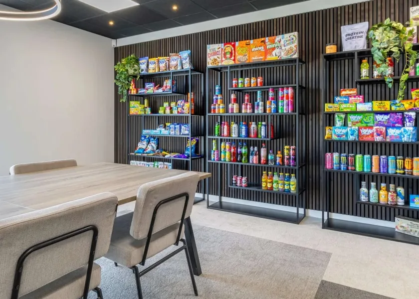BOB Distribution's showroom: a wall of shelves full of soft drinks, snacks and sweets next to a meeting table.